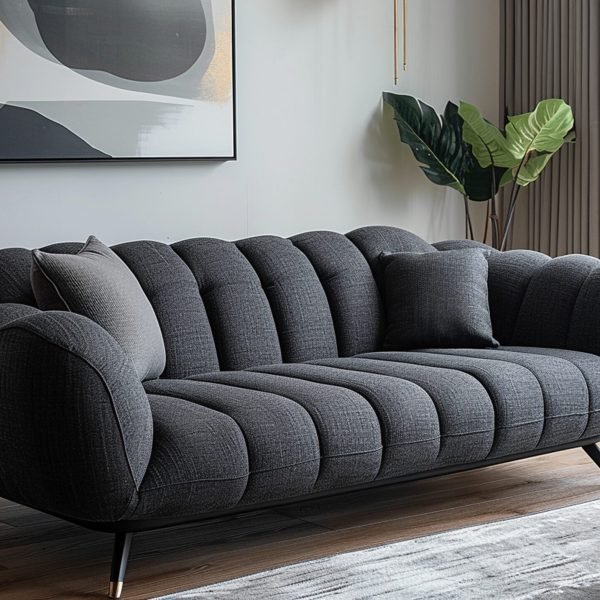 black-leather-couch-with-two-pillows-it-white-wall-it
